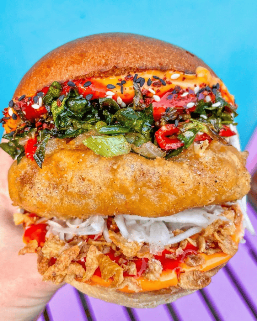 Loaded vegan burger and dirty fries from Wholesome Junkies, an award-winning vegan junk food spot in Manchester's Northern Quarter